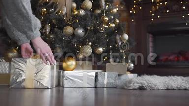 女人`手里<strong>拿着</strong>礼物的盒子放在圣诞树下，闪亮的圣诞树，<strong>花环</strong>和球，新年`